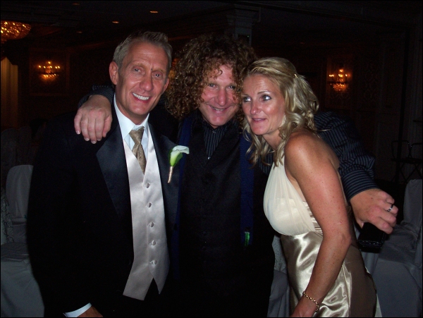 Jim poses with the bride and groom. Jim poses with the bride and groom.