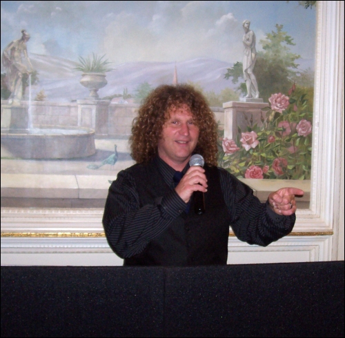 On the mic, Jim warms up the party. On the mic, Jim warms up the party.